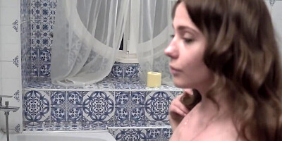 Amanda spreads her legs in the bedroom and rubs her wet pussy