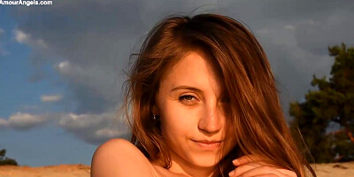 Captivating, nude stunner is loving on the beach and frolicking with her scarf during the sunset