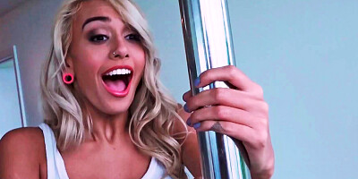 Pretty girl is dancing around a stripper pole