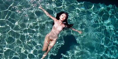 Chinese honey seducing a dark-hued boy in the pool