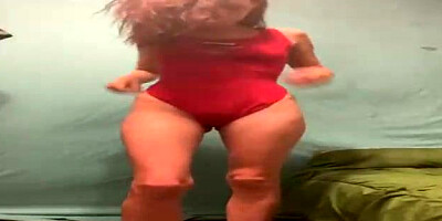 Luxurious dame is leisurely taking off her clothes in front of the camera, just for joy