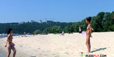 Bombastic young nudist babes sunbathe nude at the beach