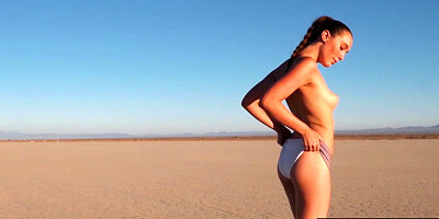 Big boobed nude babe posed in the desert