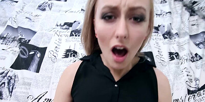 A blonde is staring into the camera while sucking a large dick
