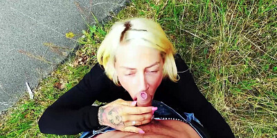 Tattooed blonde chick pleasuring horny stud in a public park