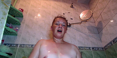 Busty MILF having fun in the shower