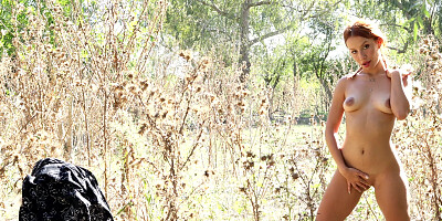 Petite redhead Loli caresses herself solo in nature
