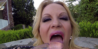 MILF Kelly Madison poses for the camera on the lawn