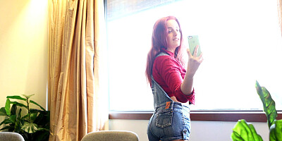 Redhead damsel Charlie Forde takes pictures of her shaved snatch