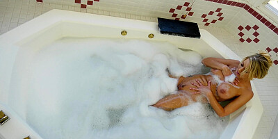 Katie Morgan is playing with her big tits and pussy in the bathtub