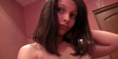 Beautiful brunette takes off her clothes on camera