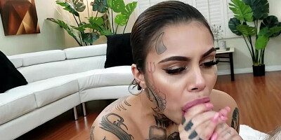 Band and inked MILF is naked giving a blowjob on camera