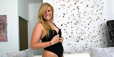 Melissa May in a black bodysuit showing off her curves