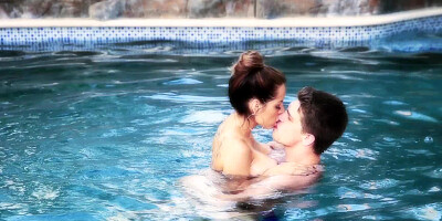 A couple is in the pool, doing amazing stuff with each other there