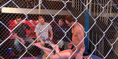 A nude blonde is getting fucked in the ring in a large cage