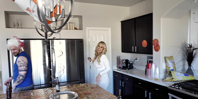 Katie Morgan is cleaning the kitchen while the guys are watching a game