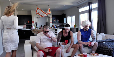 Katie Morgan is cleaning the kitchen while the guys are watching a game