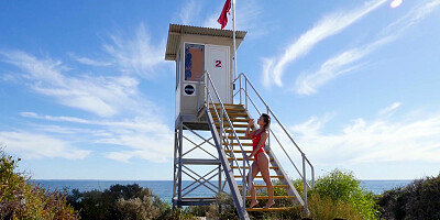 Stunning lifeguard posing on the beach