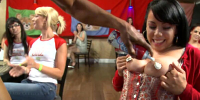 A dude performs for a crowd of screaming women in club and humps