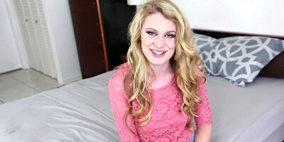 A blonde with hot long curly hair is shown sucking a large dick