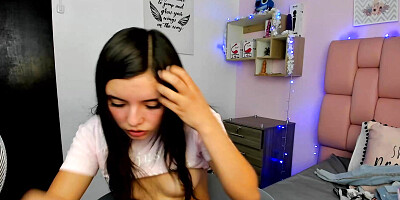 Cute horny young girl with a cute face gets her throat stuffed with a big dildo while a toy vibrates inside her pussy