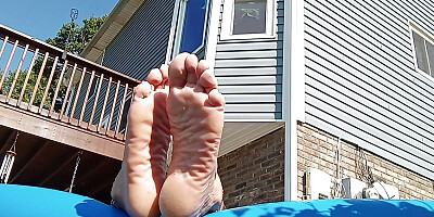 My Girlfriend showing off her toe',s soles and tits in the pool