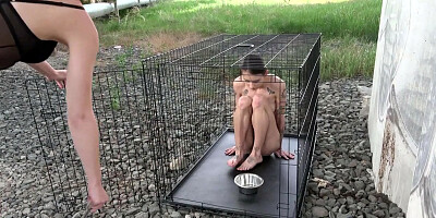 Exposed in the public pillory cage by Femdom Austria