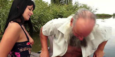 A brunette with a big ass is getting fucked by the river outdoors