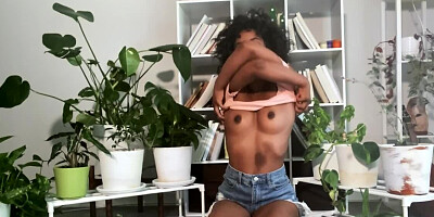 Naughty and skinny black gal waters plants using her own squirt
