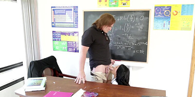 A brunette with long hair is getting penetrated on the desk