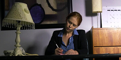 A babe is pressed against the desk and fucked really well