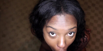 A black chick is kissing a large white dick close up to us