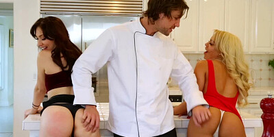 Two bitches are getting what they need in the kitchen from a chef