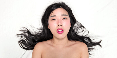 Elle Lee is orgasming while masturbating in a white room