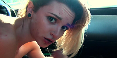 A blonde with large eyes is getting fucked in the car well