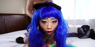 A bitch with blue hair is getting her pussy pounded on the sheets