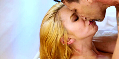 A blonde with a sexy ass is licking balls on the bed and she loves it