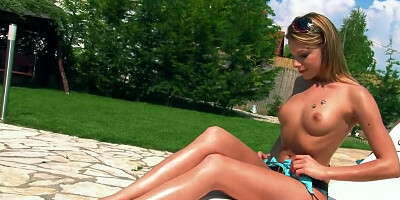 Superb blonde girl plays with her kitty on a sunny day