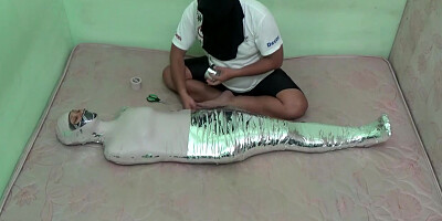 Beautiful Girl In Swimsuit Wrapped Tightly Into A Mummy In 2 Layers Of Duct Tape