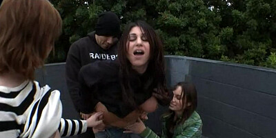 Sexy girls are giving a blow job out in public in a threesome