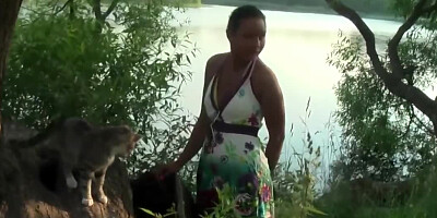 A lovely amateur couple is walking through the forest and goofing around