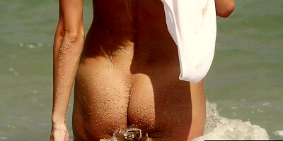 Skinny blondie stripping at the beach