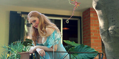 Big tits redhead posing in the garden