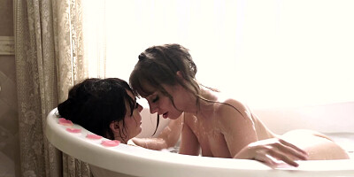 Attractive lesbian couple tenderly makes love in the bathroom