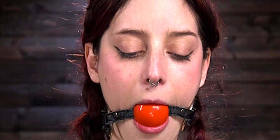 Redhead bound in a bridge position whipped