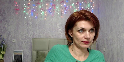 Busty ginger MILF showing boobs in sweater