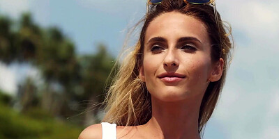 Cute blonde MILF psoing on the beach