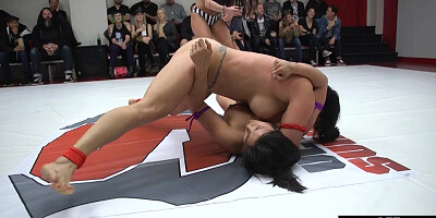 Public lesbian wrestlers fight in arena in front of crowd