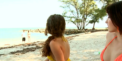 Two juicy girls are giving nice handjobs on the beach