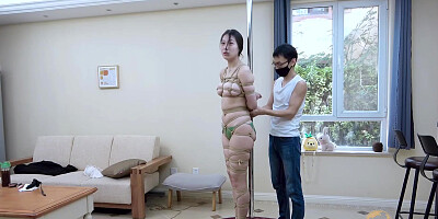 Tied to a pole with dildo gag